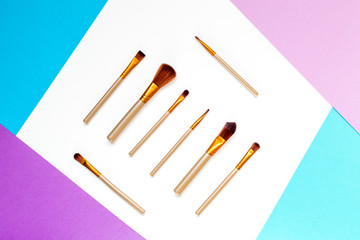 cosmetic set with brushes on woman table background top view mockup