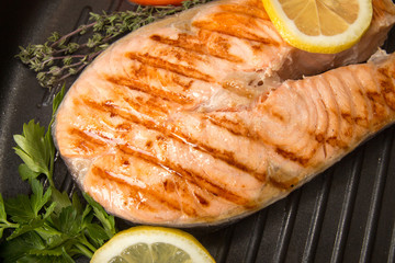 Grilled salmon fillet on frying pan. Steak of salmon