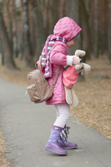 Fototapeta premium Little girl dropped the doll on a walk