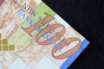 Israeli banknote hundred shekels on a dark background close up