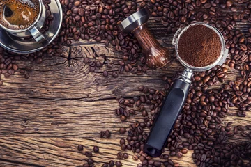 Foto op Plexiglas Coffee. Black coffee with coffee beans and portafilter on old oak wooden table. © weyo
