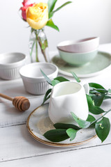 ceramic tableware with flowers on white background