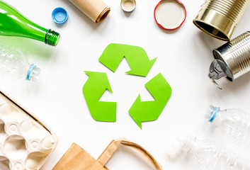 waste recycling symbol with garbage on white background top view