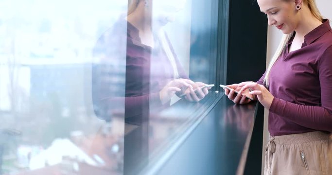 female manager using cell telephone in office interior