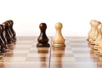 Black and white chessmen on chessboard