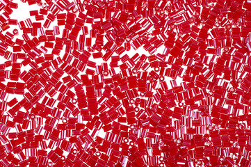 Crimson-red glass beads background - closeup beads texture