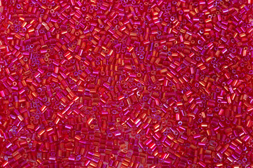 Crimson-red glass beads background - closeup beads texture