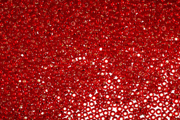 Crimson-red glass beads background - closeup beads texture