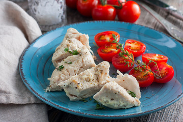 Dietary boiled chicken breast fillet with dumplings on a wooden table, selective focus
