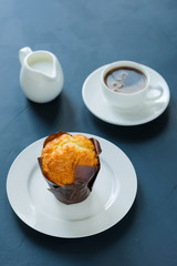 Breakfast. Coffee with milk and muffin.