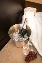 bottle of champagne and glasses in hotel room