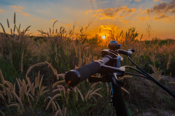 Fototapeta na wymiar Closeup Bike in countryside sunset background.