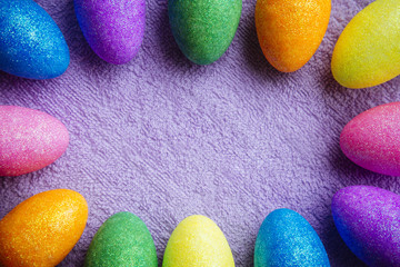 Colorful Easter Eggs on a fabric background. Creative concept