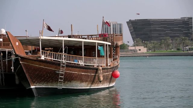 Traditional dhow sailing vessel docked beside the Corniche in Doha, Qatar.