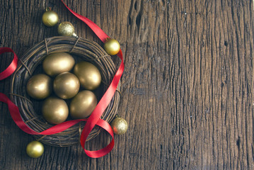 gold eggs with red ribbon