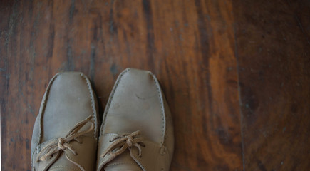 Old worn sneakers on a background of boards