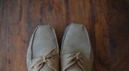 Old worn sneakers on a background of boards