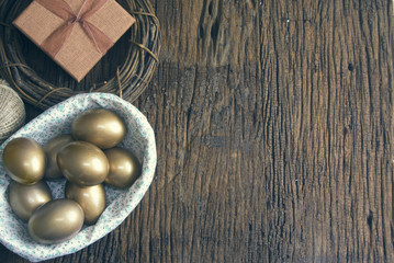 gold eggs with prop on wood