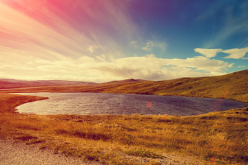 Mountain lake at sunset. North Cape. Nature Nordkapp, Norway