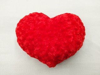 Close-up. Soft red heart. Emotion with eyes and smile. A symbol of love and happiness. 