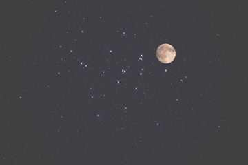 Moon and stars on a dark sky.