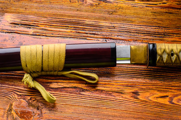 Japanese sword katana on wooden background