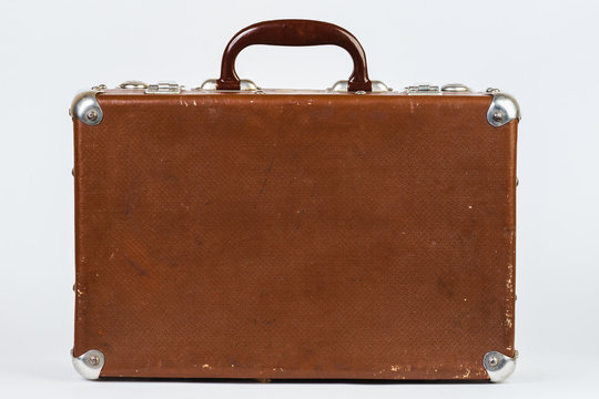 A brown suitcase. Vintage luggage. Vintage travel bag. Isolated on white background.