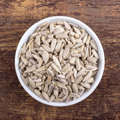 sunflower seeds / Porcelain bowl with peeled sunflower seeds