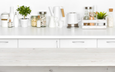 Fototapeta na wymiar Wooden planks table over blurred image of kitchen bench interior