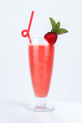 Red strawberry summer smoothie decorated with mint
