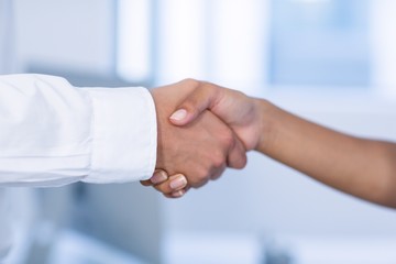 Close-up of doctor and patient shaking hands