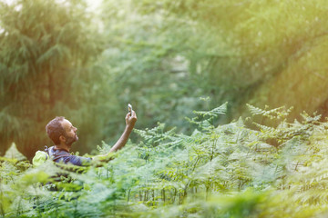 Hiker searching a mobile phone signal, being lost