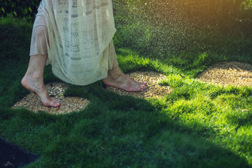 girl walking barefoot on the stones in heart shape