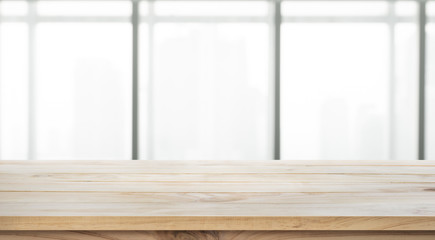 Empty of wood table top on blur big window office background.For create product display or design visual layout