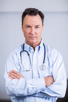 Portrait of confident doctor standing with arms crossed