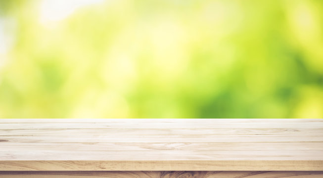 Fototapeta Empty wood table top on blur abstract green garden in the morning.For montage product display or key visual layout