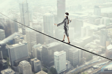 She is walking blindfolded . Mixed media