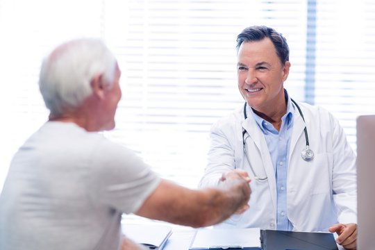 Doctor shaking hands with senior man