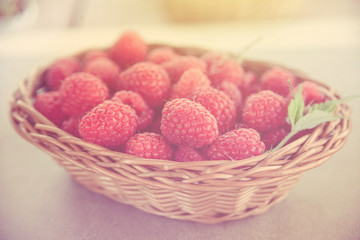 Fresh summer raspberry in a basket. Selective focus.Toned.