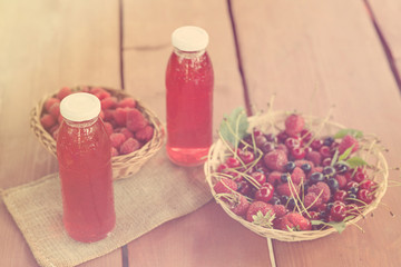 Two bottles of cold stewed fruit from assorted berries.Toned.