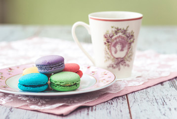 multicolored macaroons with cofee
