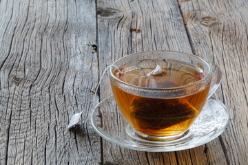 Cup of tea with tea bag on table