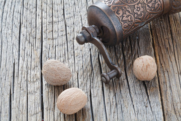 Nutmeg whole  on wooden background, selective focus