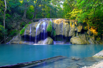 Fototapeta na wymiar Erawan waterfalls, beautiful evergreen middle class has 7 lies a national park in Kanchanaburi, Thailand.