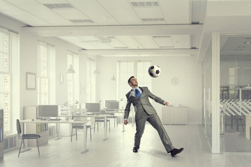 He is football fan . Mixed media