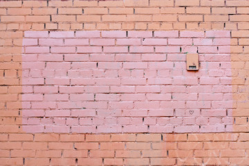 Yellow and brown brick wall with painted splotch as background or texture