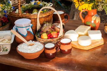 Dairy products on wooden table. Cheese and milk on the table in an earthenware dish. Concept of rural organic food. Food background. concept of small business.