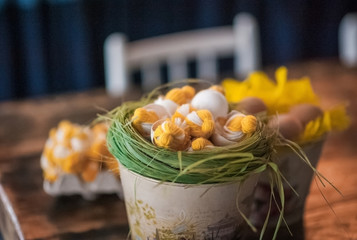 The loft-house is decorated for Easter. Easter decor home. Festive mood in a beautiful house with greenery, colorful eggs, garland.