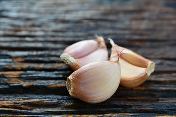 piece of garlic for healthy and cooking put on wooden table.