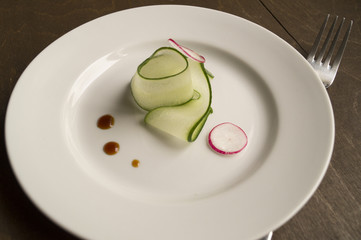 thinly sliced cucumber on a white plate